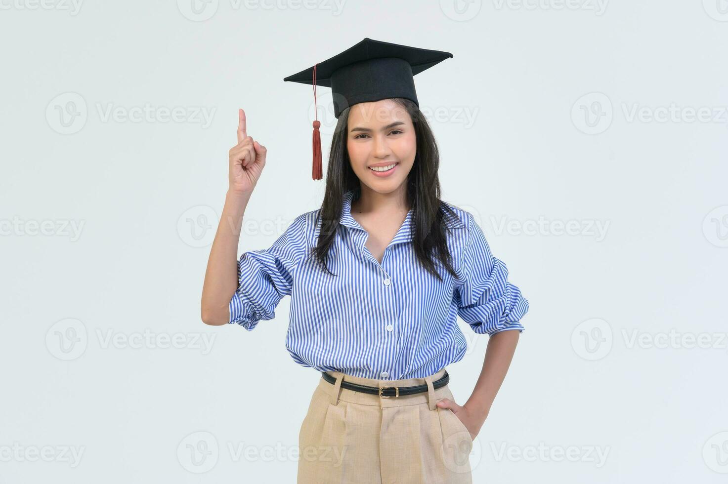 Portrait of happy Beautiful woman in graduation gown over white background photo