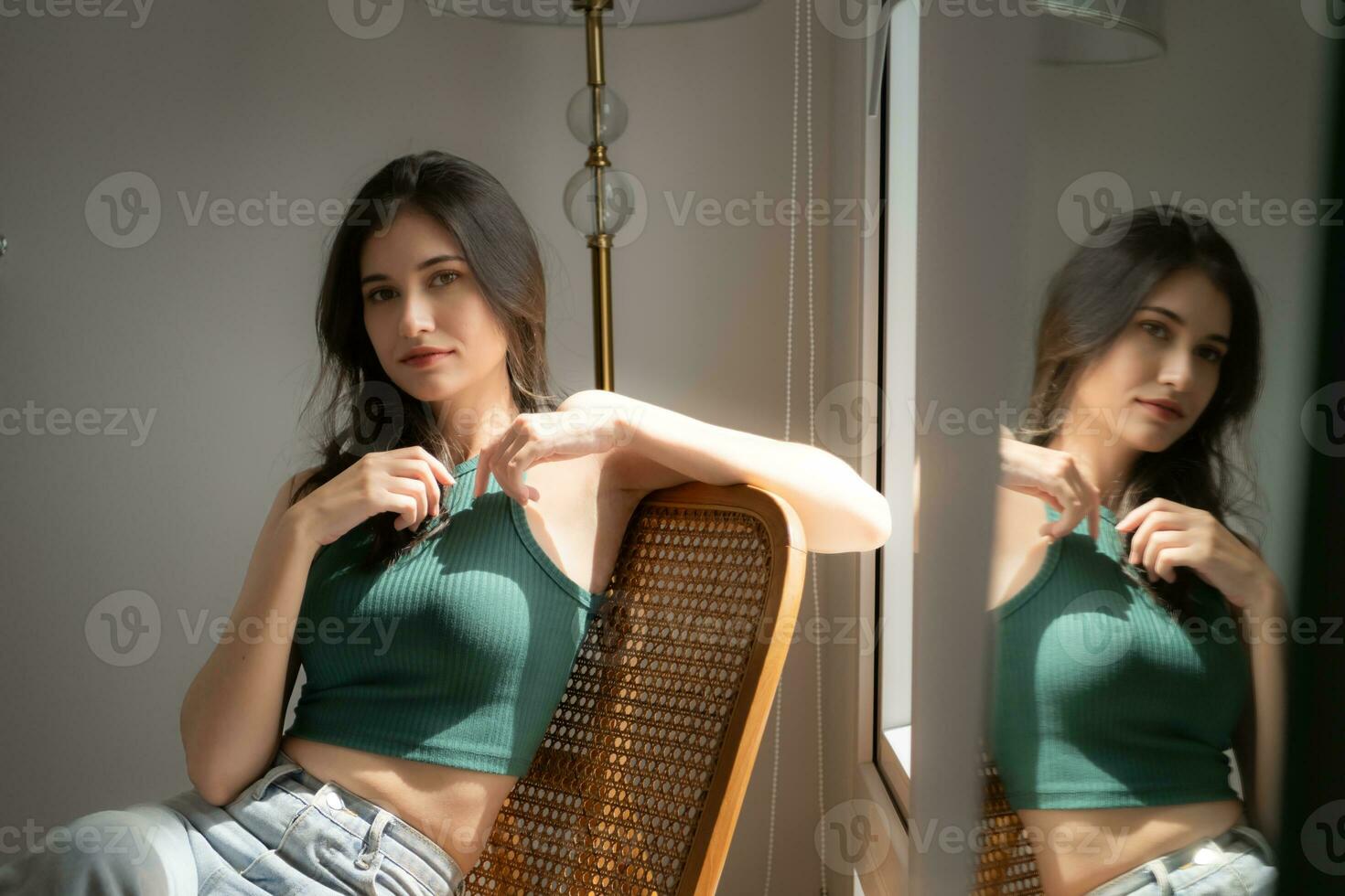 Beautiful asian woman sitting on chair and looking out the window photo