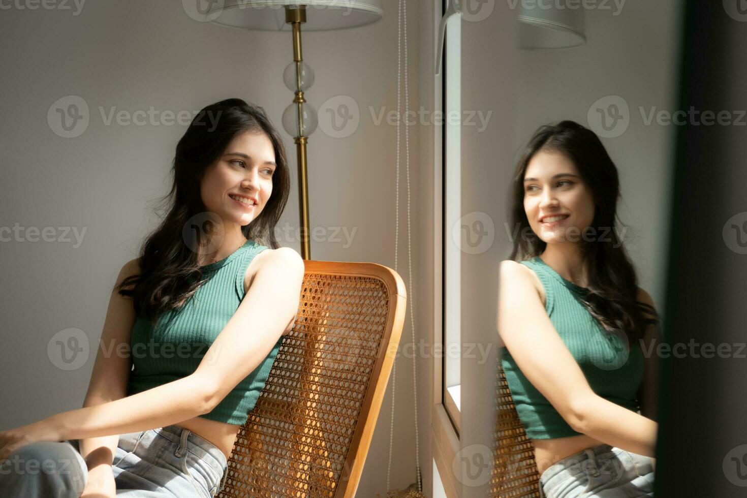 Beautiful asian woman sitting on chair and looking out the window photo