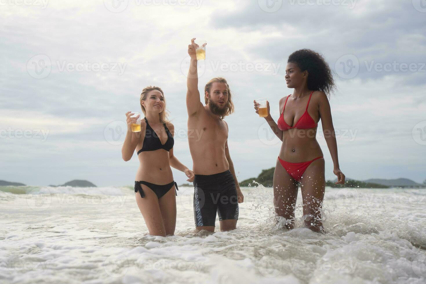 Group of friends having fun on the beach. Young women having fun on the beach. photo