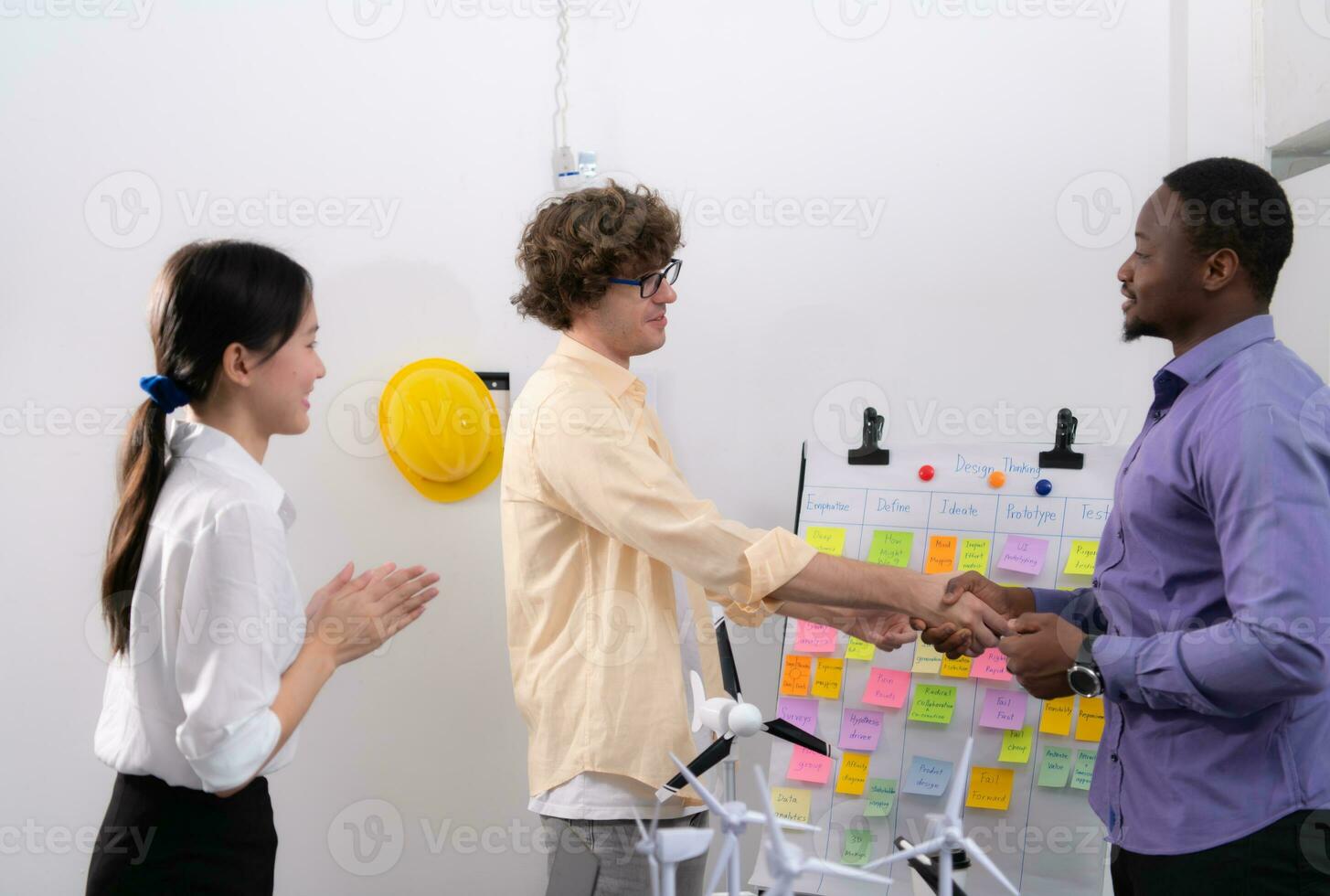 Group of multi-national team of architects and designers is meeting to brainstorm designs for wind turbines to capture wind energy and convert it into electrical energy. photo