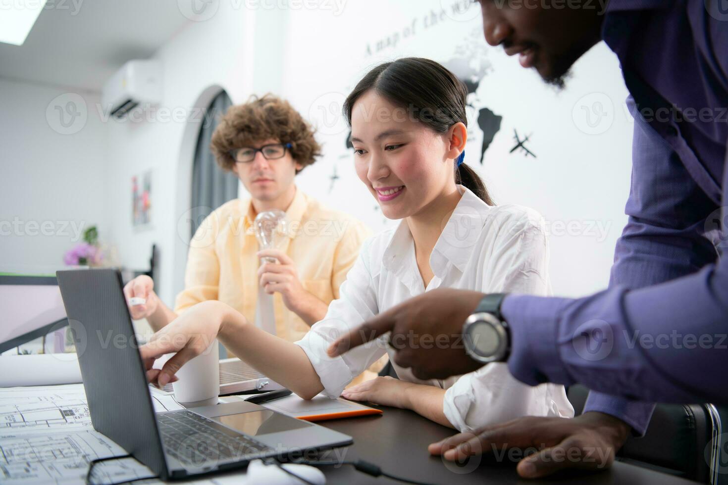 Multiethnic team of architects and designers are meeting new project, He carries a light bulb that should not be used in buildings because it is not energy efficient and not earth-friendly. photo