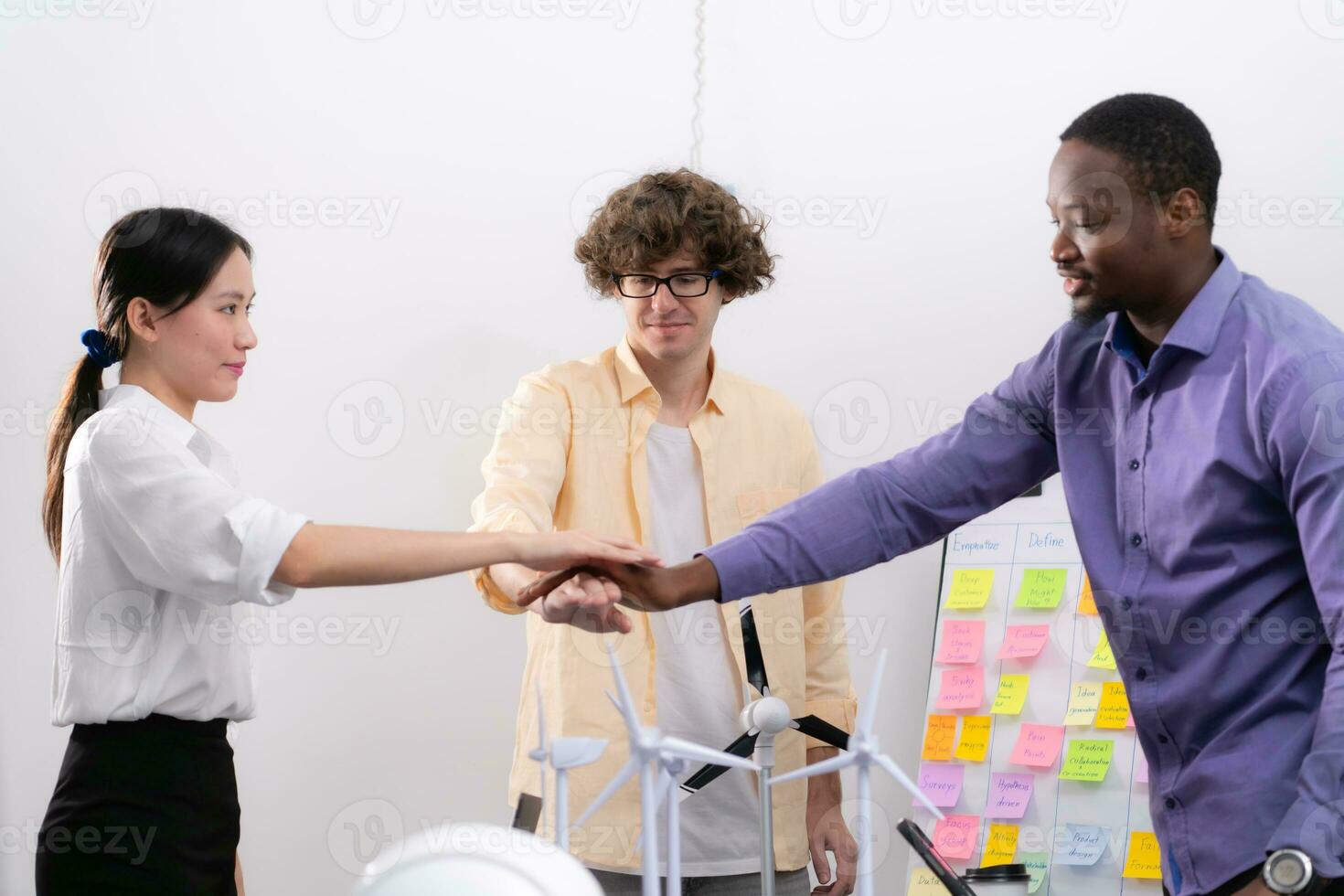 Group of multi-national team of architects and designers is meeting to brainstorm designs for wind turbines to capture wind energy and convert it into electrical energy. photo