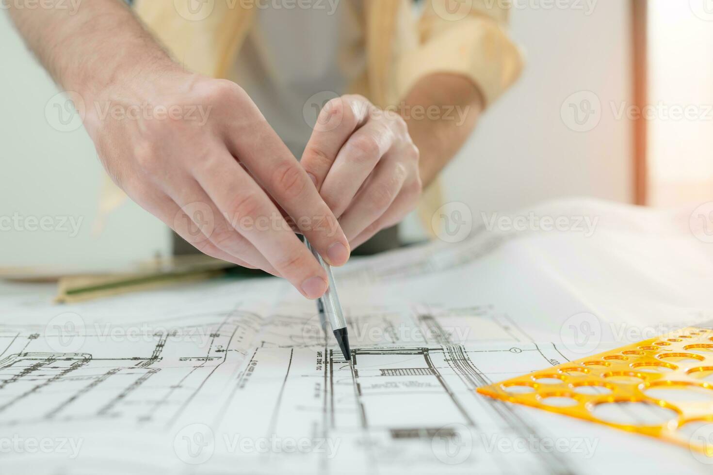 Group of architect and designer is designing a green home building that takes advantage of natural energy such as wind and sunlight. photo