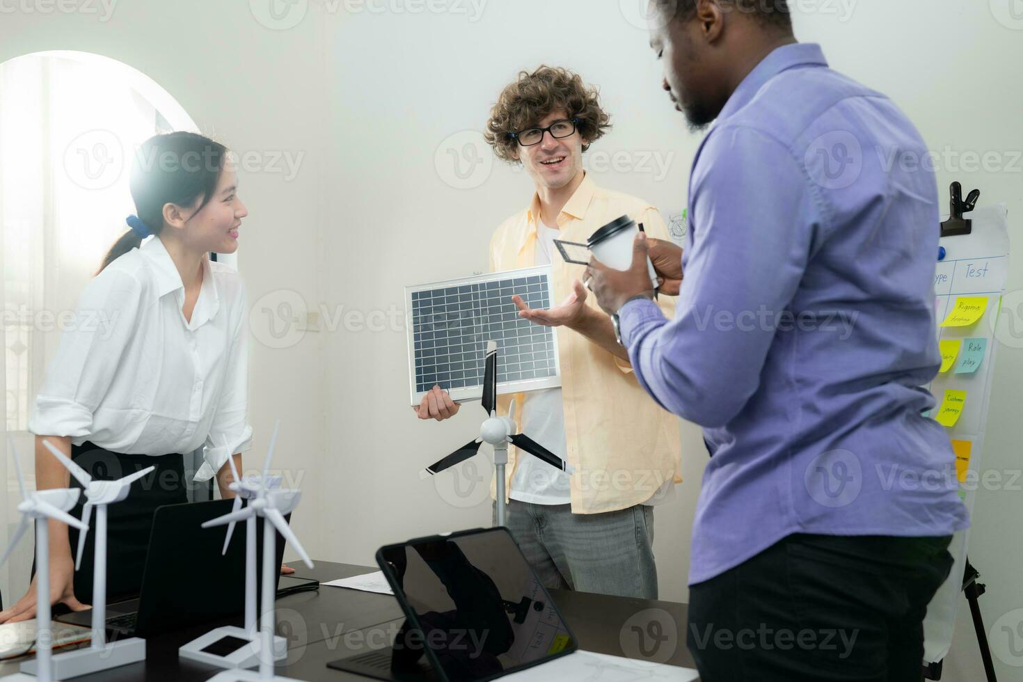 A multi-national team of architects and designers is meeting to brainstorm designs for solar cell panels for office and residential buildings photo
