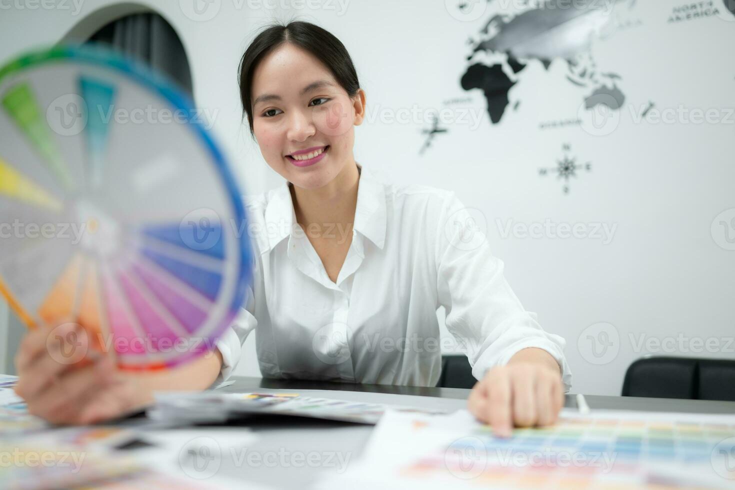 Young female architect and designer are rethinking the choice of color scheme for designing a smartphone application. photo