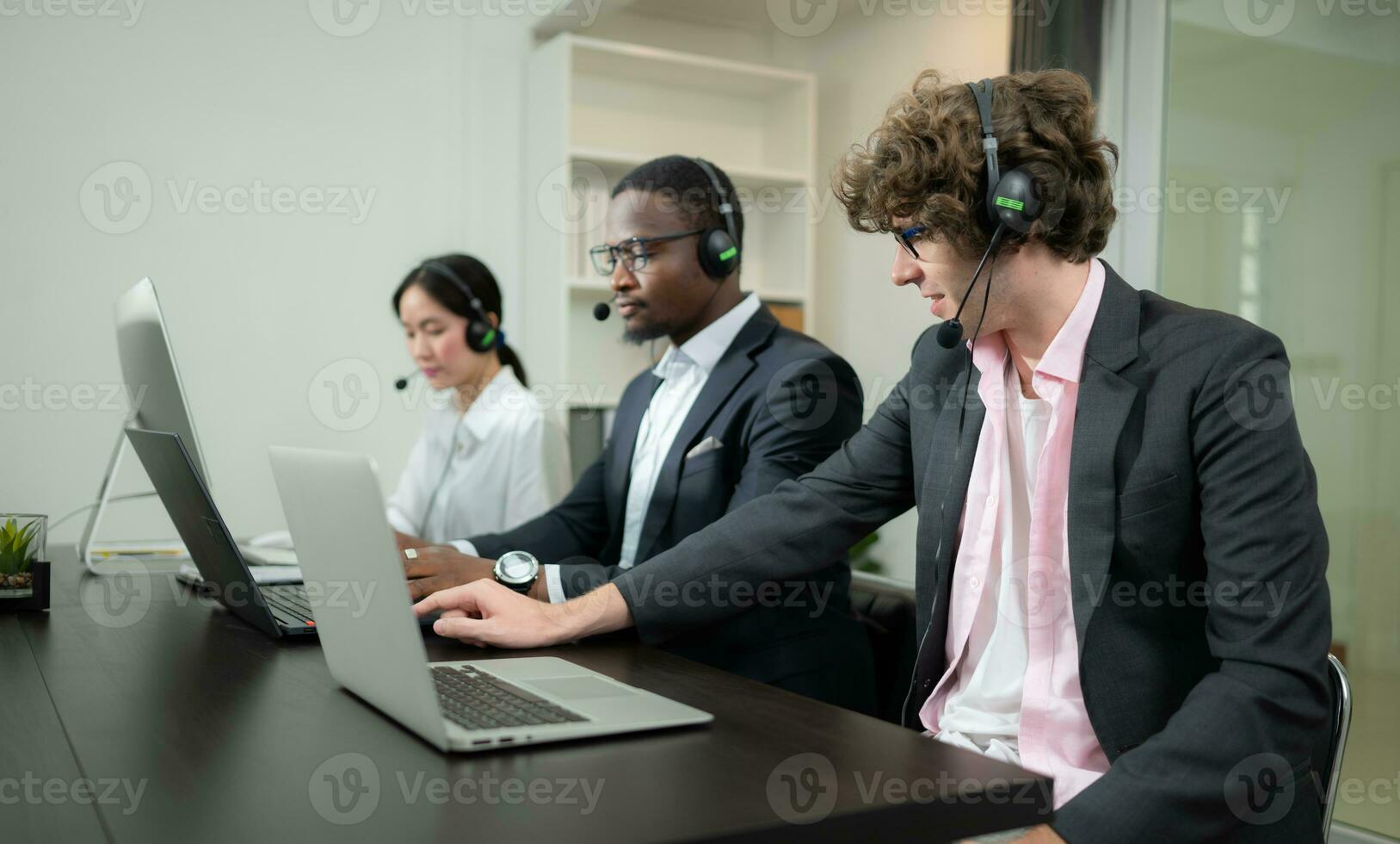 Group of business people wearing headset working actively in