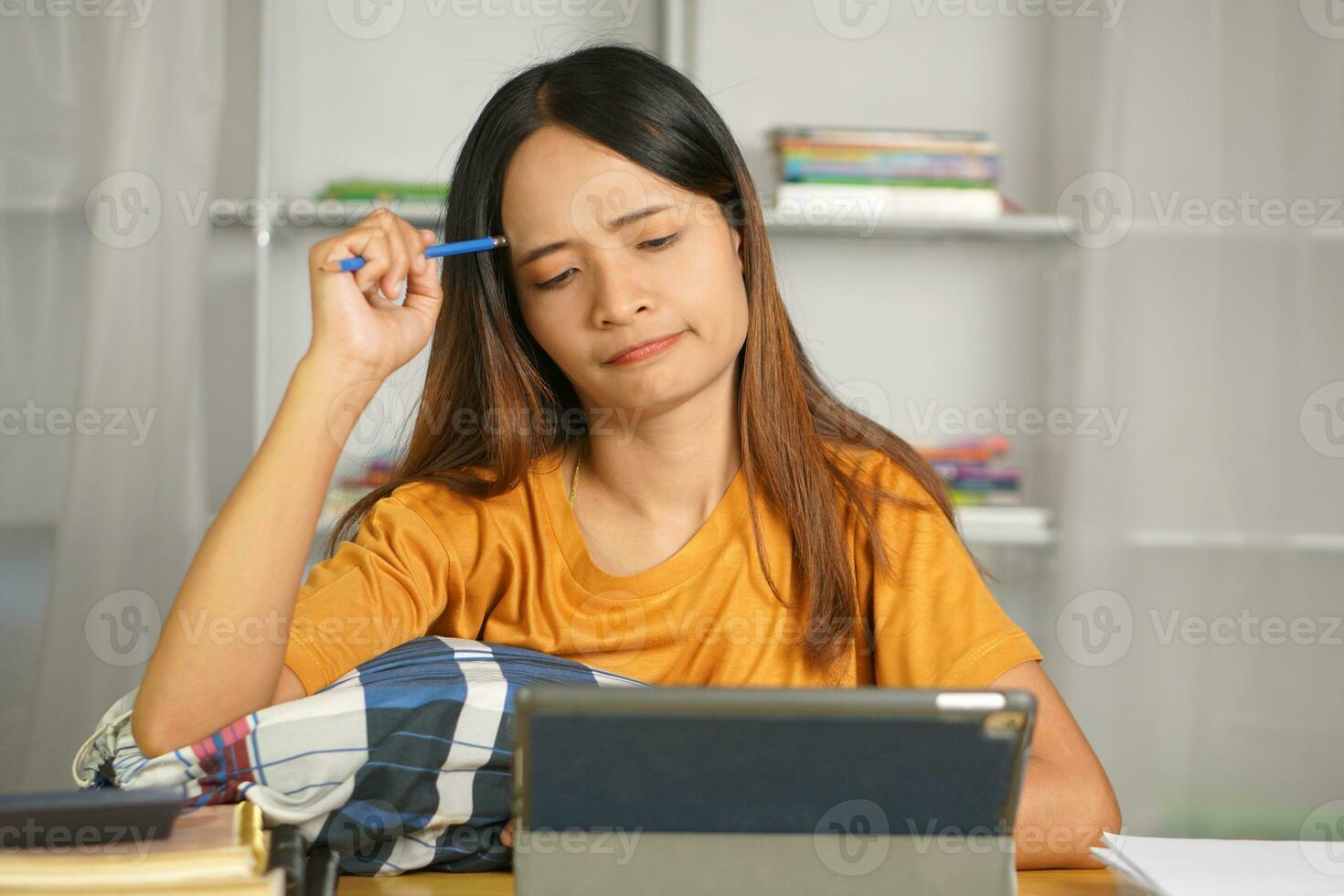 Asian woman working from home Tired of paperwork that is not completed on time photo