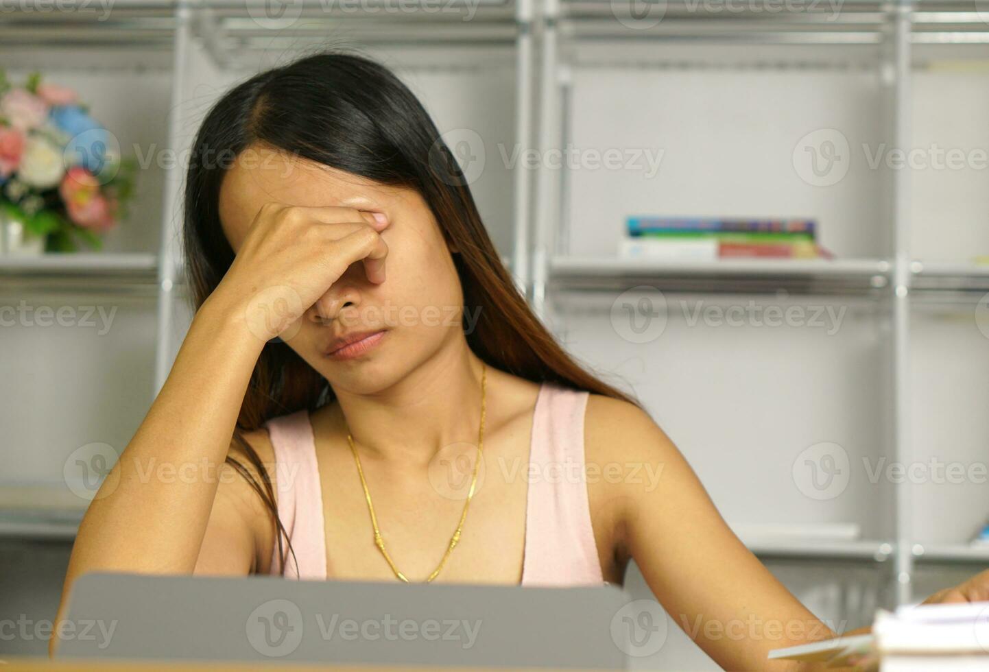 Asian woman working from home Tired of paperwork that is not completed on time photo