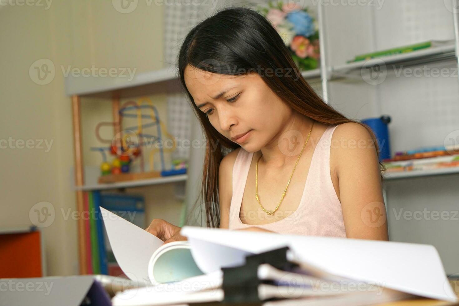 Asian woman working from home Tired of paperwork that is not completed on time photo