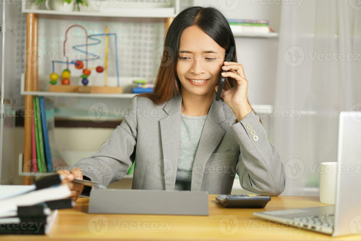 Businesswoman contacting customers by phone photo