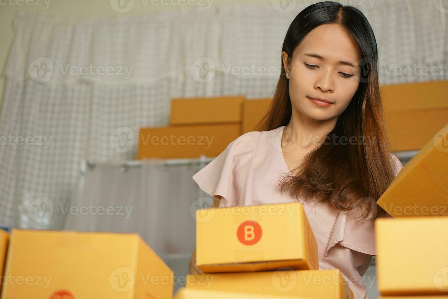 Online sellers check product boxes before delivering to customers. photo