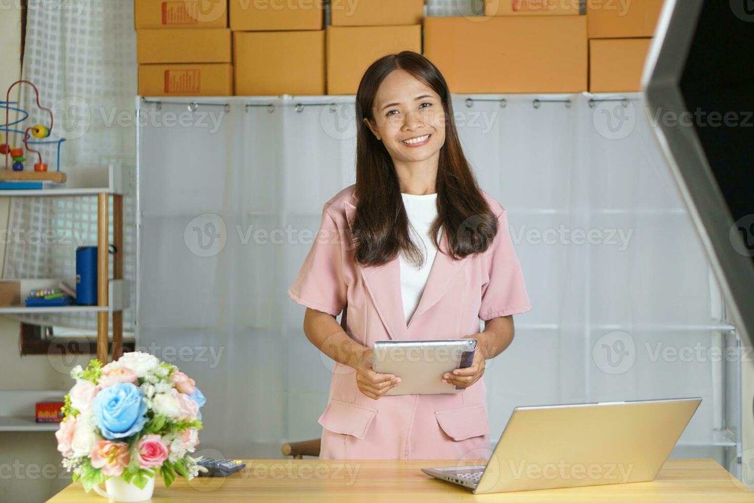Business woman takes product promotional photos in a photo studio.