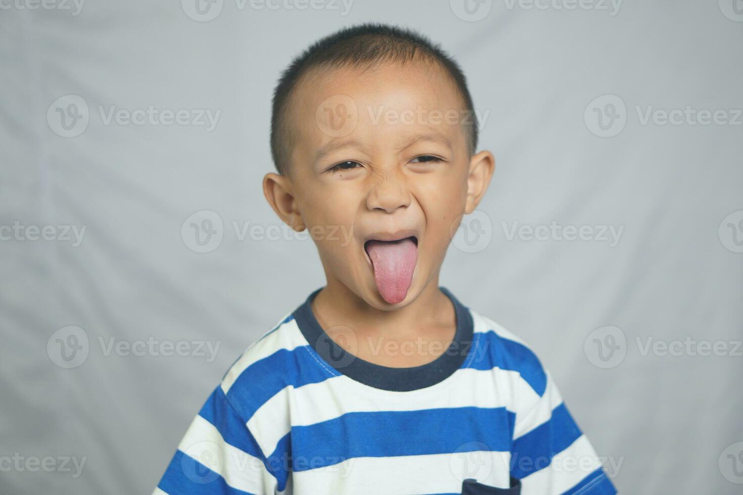 Happy boy taking pictures in the studio photo