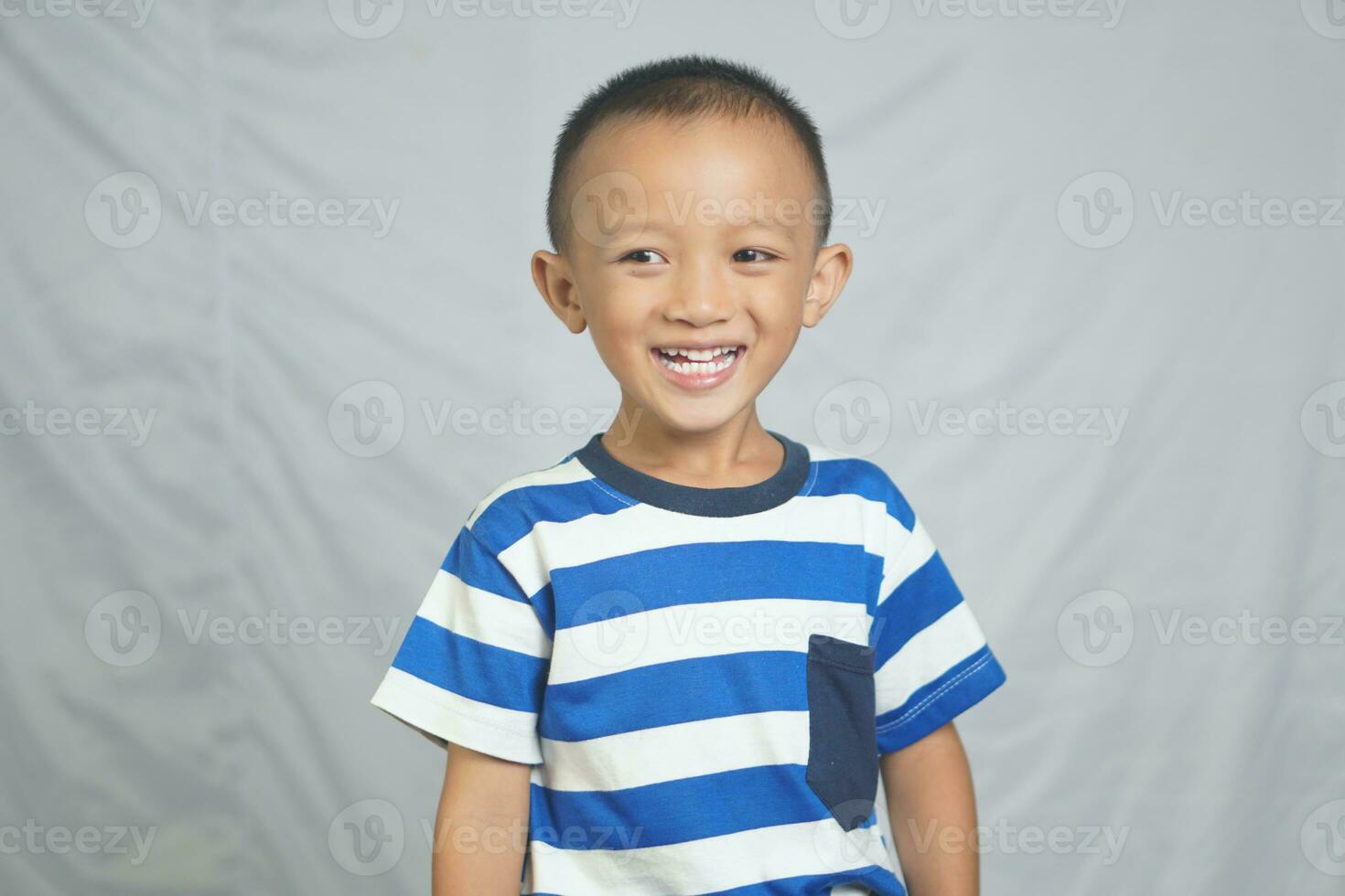 Happy boy taking pictures in the studio photo