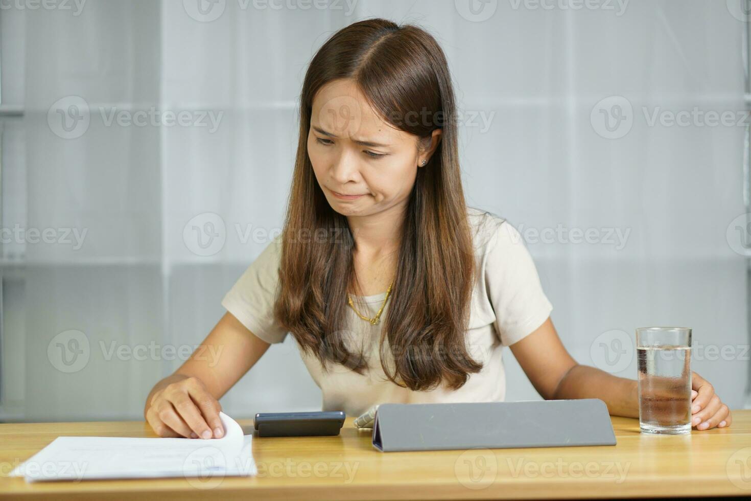 Asian woman working at home Got stressed after looking at documents photo