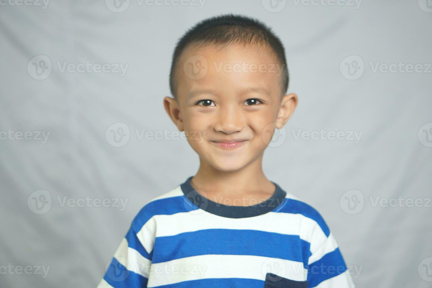 Happy boy taking pictures in the studio photo