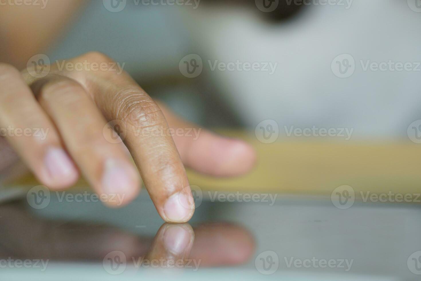 Asian woman working at home Use your hand to touch the computer screen. photo