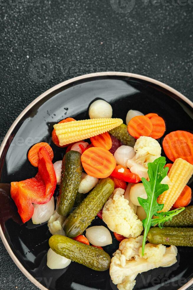 vegetables pickled salad spicy cucumber, gherkin, carrot, onion, cauliflower, pepper appetizer meal food snack on the table copy space food background rustic top view photo