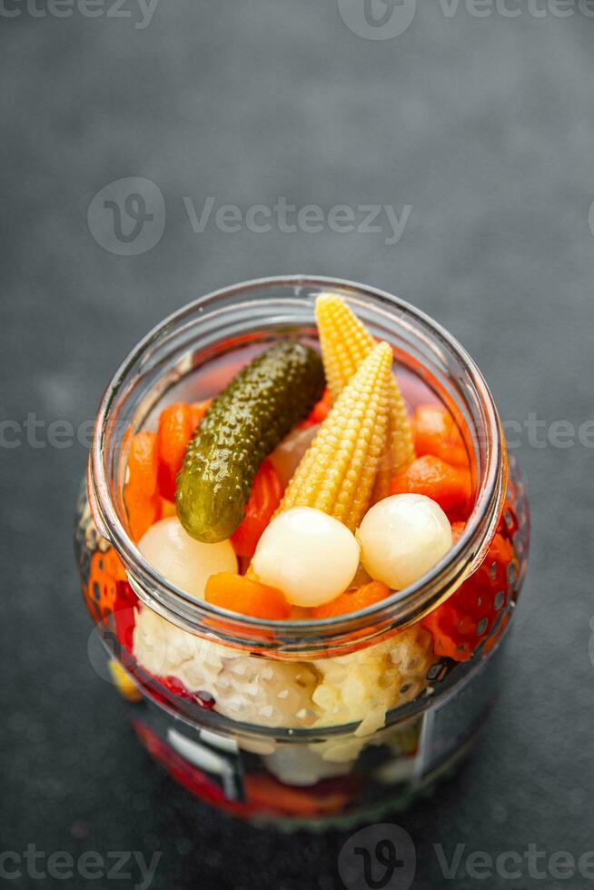 vegetables pickled salad spicy cucumber, gherkin, carrot, onion, cauliflower, pepper appetizer meal food snack on the table copy space food background rustic top view photo