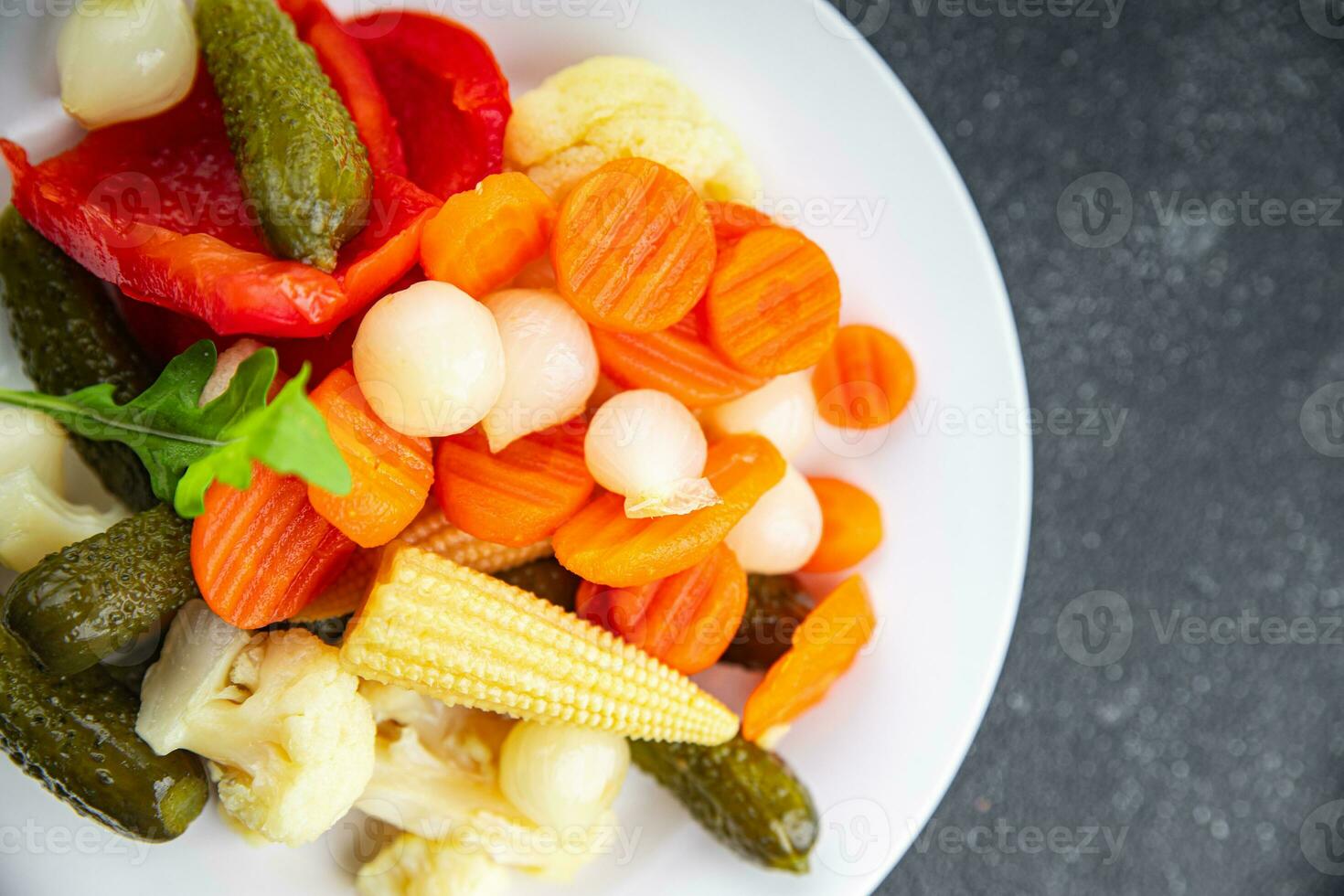 vegetables pickled salad spicy cucumber, gherkin, carrot, onion, cauliflower, pepper appetizer meal food snack on the table copy space food background rustic top view photo