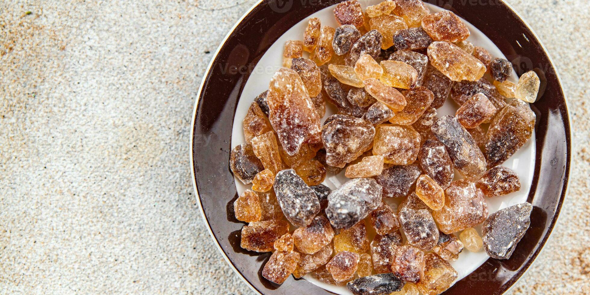 cane sugar rock sugar crystals pieces candy brown sugar candied sugar big rock caramel eating appetizer meal food snack on the table copy space food background rustic top view photo