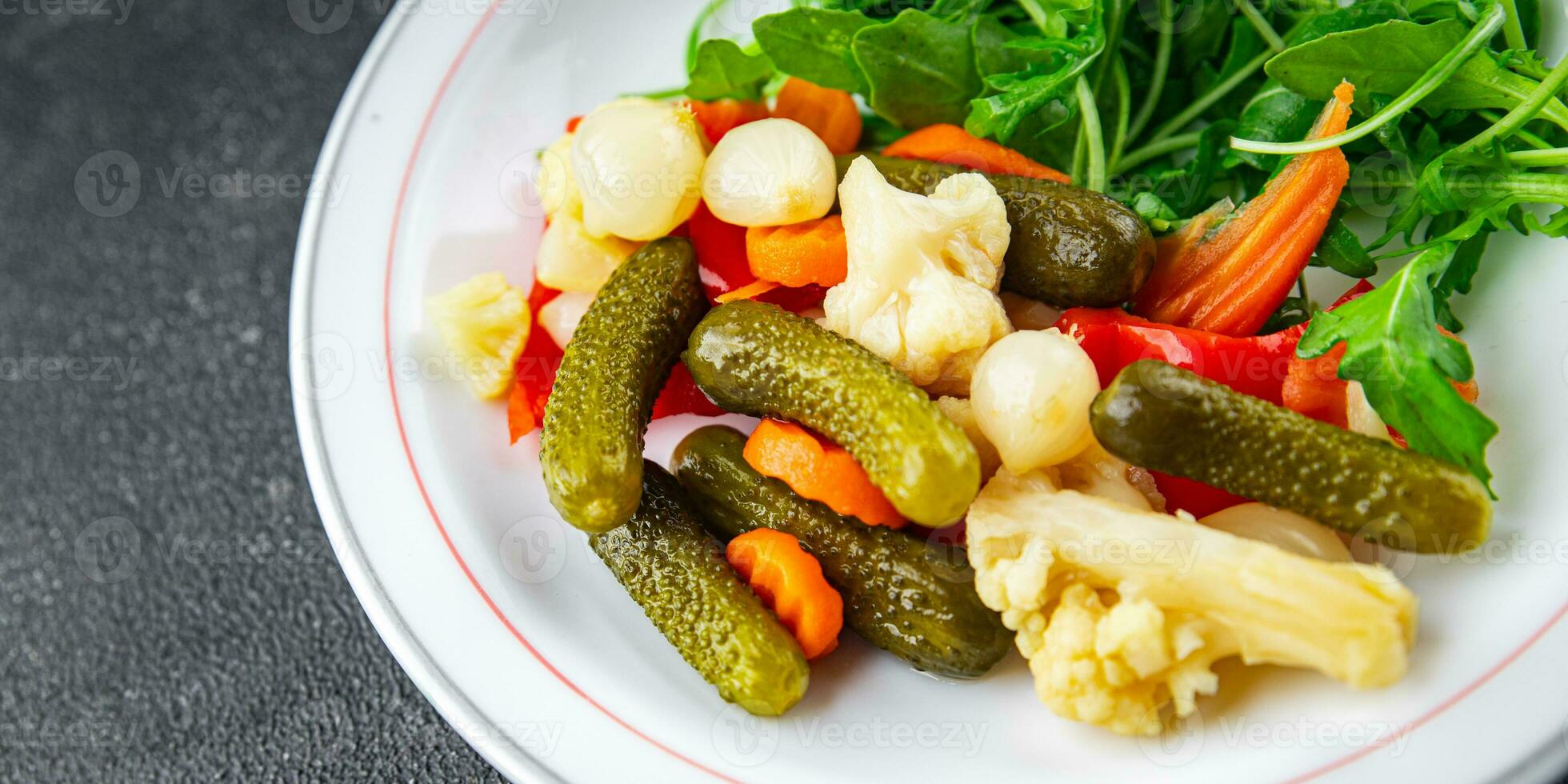 salad vegetable pickled tasty spicy cucumber, gherkin, carrot, onion, cauliflower, pepper appetizer meal food snack on the table copy space food background rustic top view photo