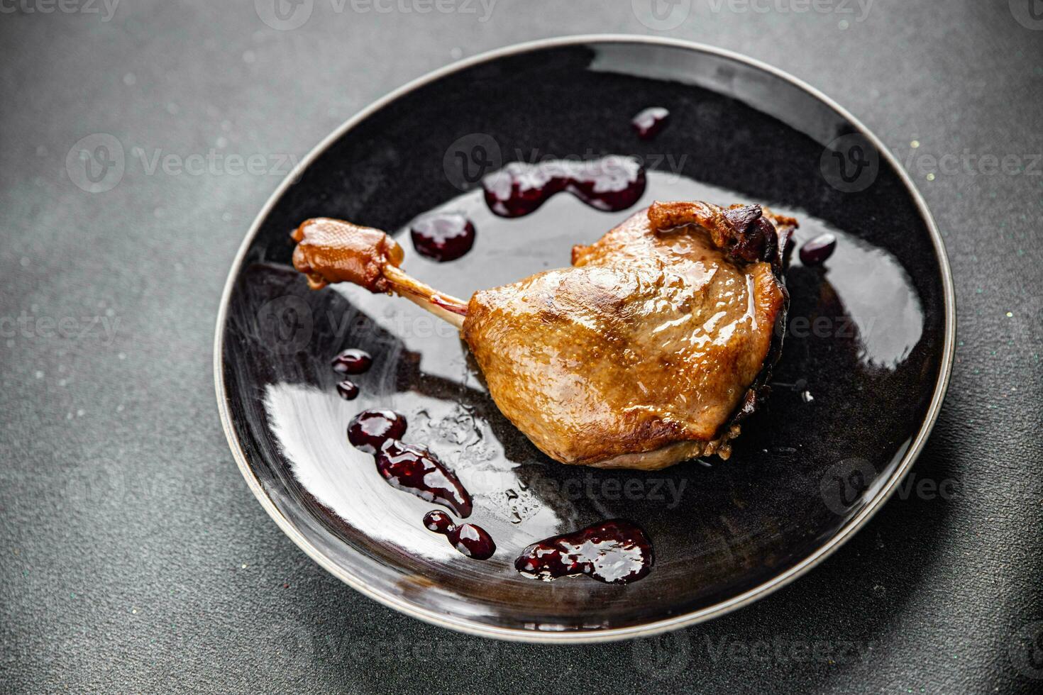 duck leg confit with berry sauce poultry meat second course vegetable delicious healthy eating cooking appetizer meal food snack on the table copy space photo