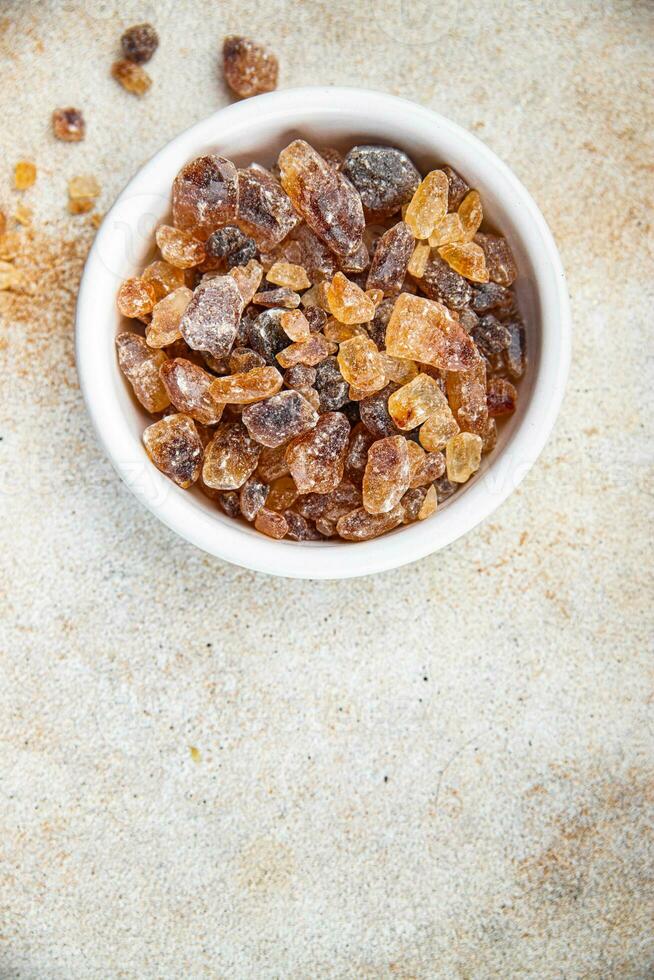 cane sugar crystal rock pieces candy brown sugar candied big rock caramel crystals sugar  taste eating cooking appetizer meal food snack on the table copy space food background rustic top view photo