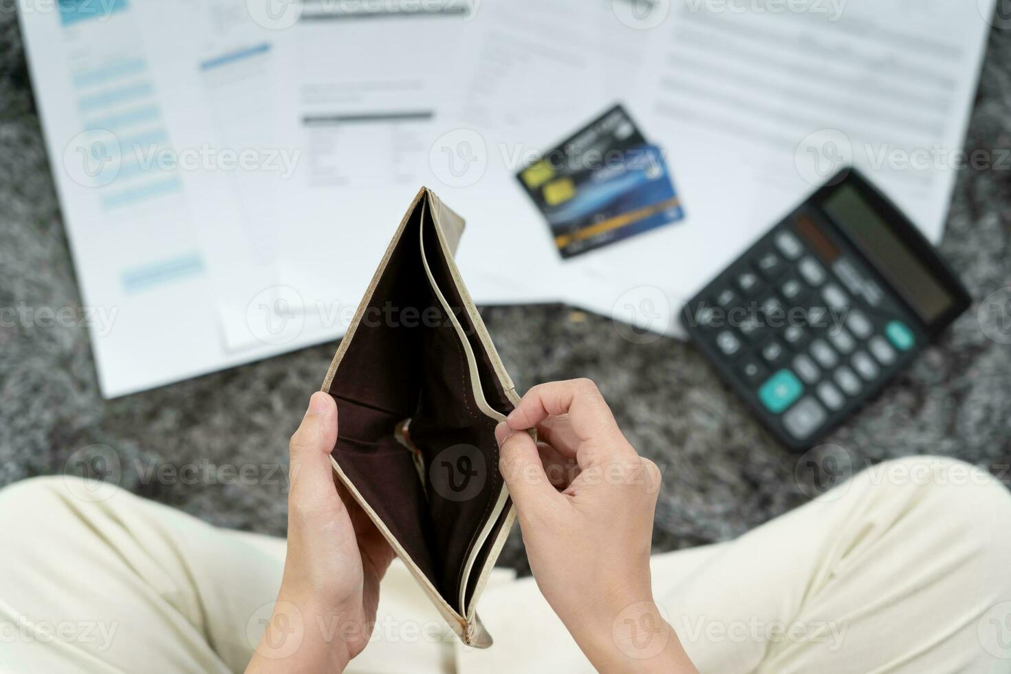 Stressed and headache woman with large bills or invoices no money to pay to expenses and credit card debt. shortage, Financial problem, bankruptcy, mortgage, loan, bankrupt, poor, empty wallet photo