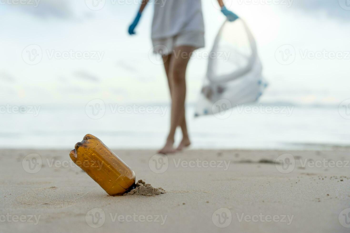 Save water. Volunteer pick up trash garbage at the beach and plastic bottles are difficult decompose prevent harm aquatic life. Earth, Environment, Greening planet, reduce global warming, Save world photo