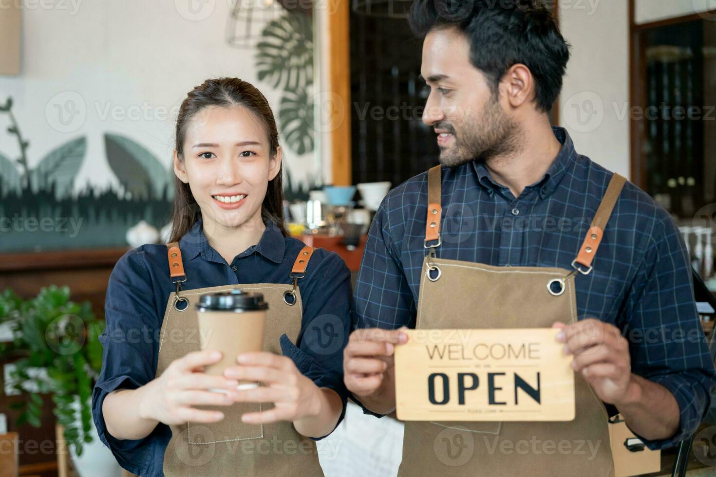 Asia couple owner happy the first day of small business cafe. guarantees safety, cleanliness, open the coffee shop. New normal. SME, welcome, restaurant, home made, family photo