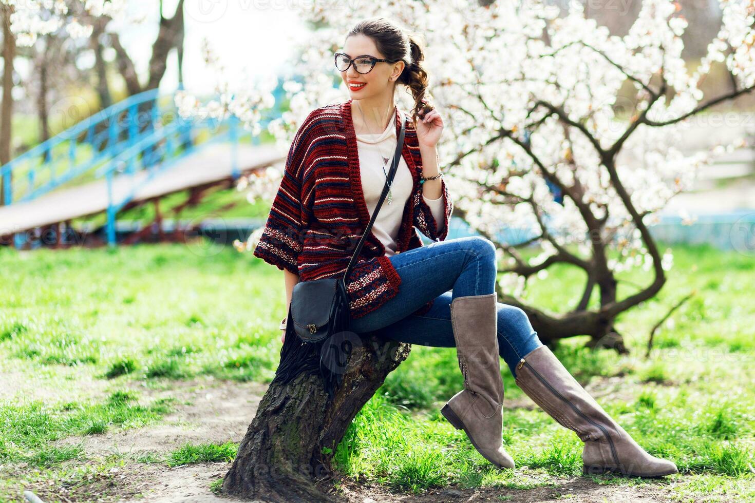 Sunny spring  portrait of happy young woman laughing and posing near flower tree. photo