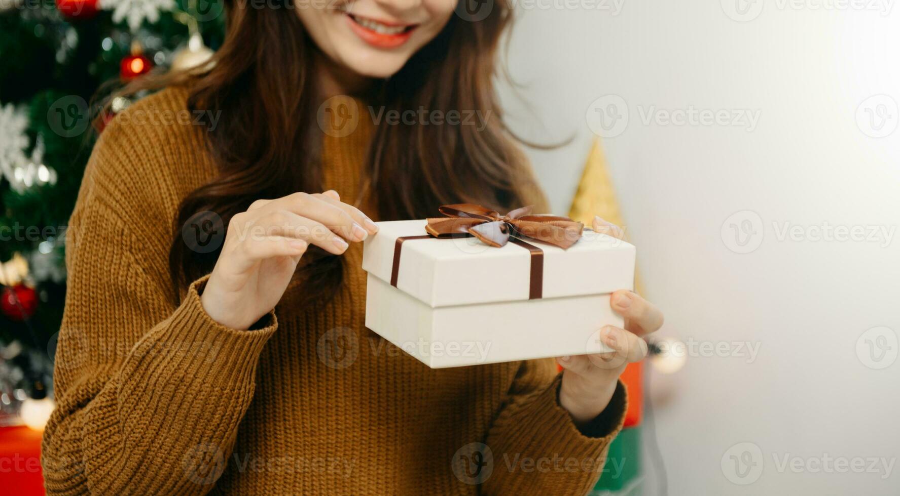 Asian young happy girl kid and decorate Christmas tree. Young little adorable child to celebrate holiday Xmas thanksgiving party  in house. photo