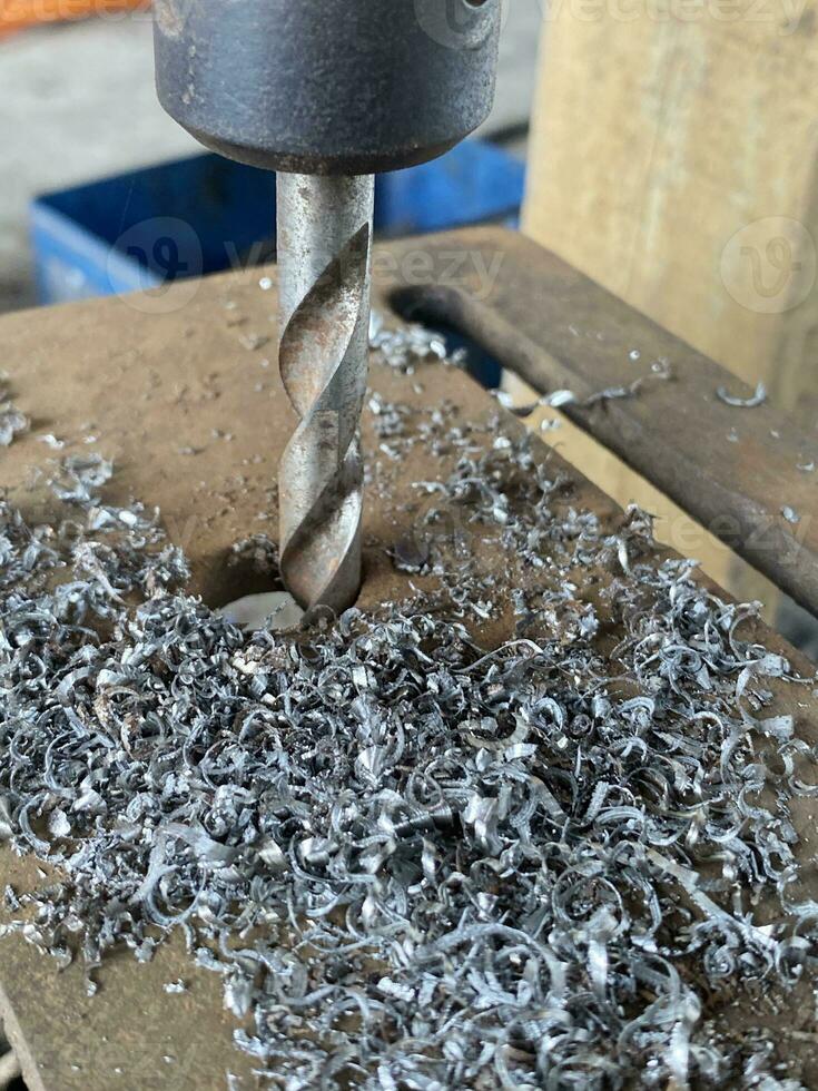 close up metal drill in workshop photo