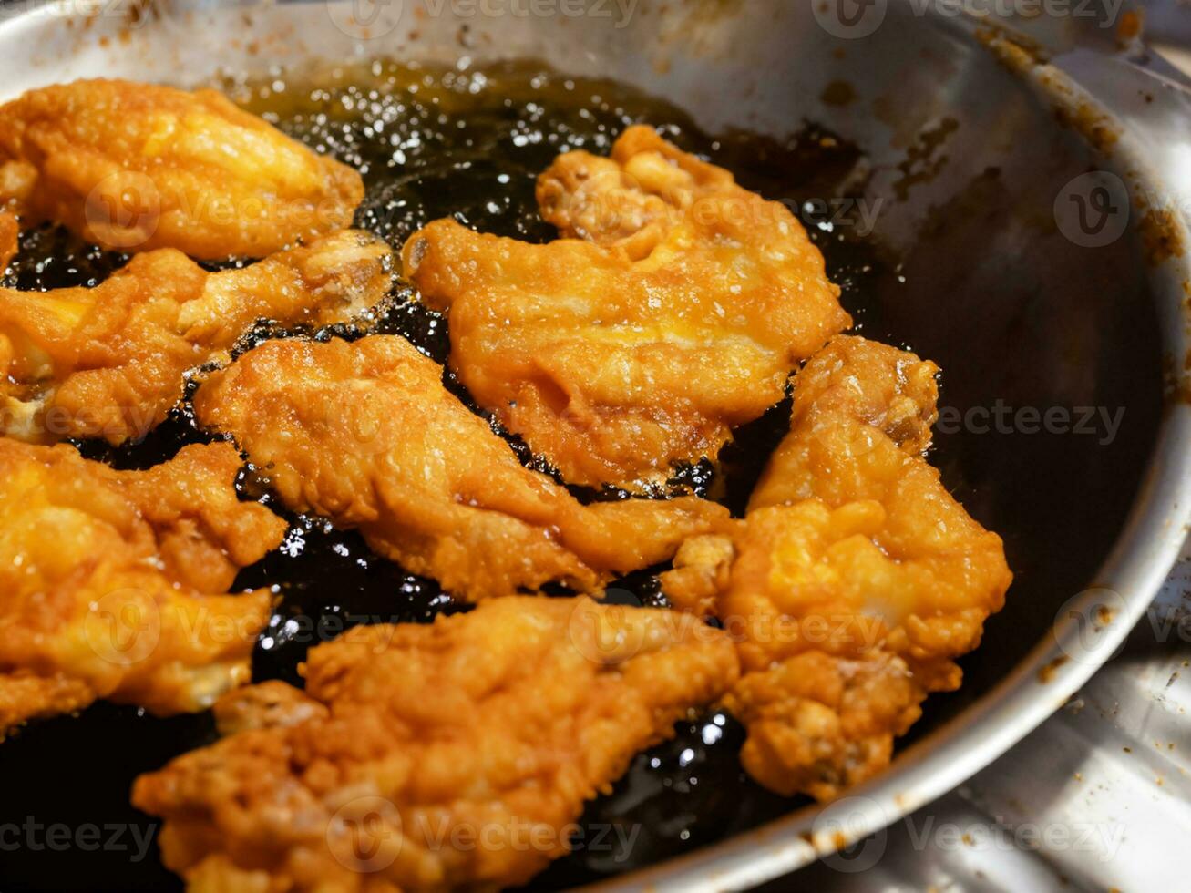 close - up of chicken wings on a frying pan photo