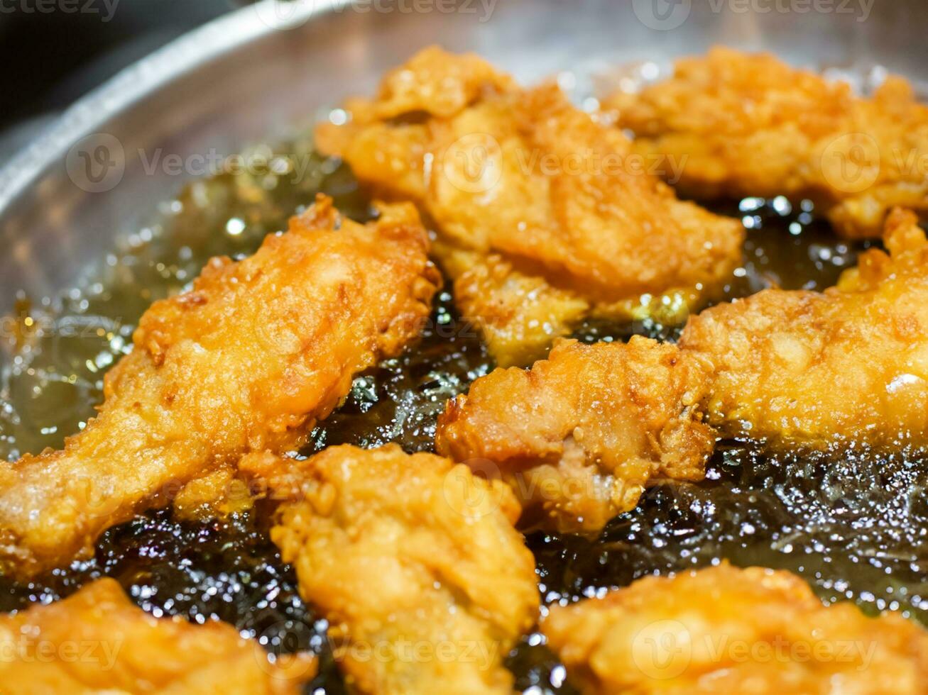 close - up of chicken wings on a frying pan photo