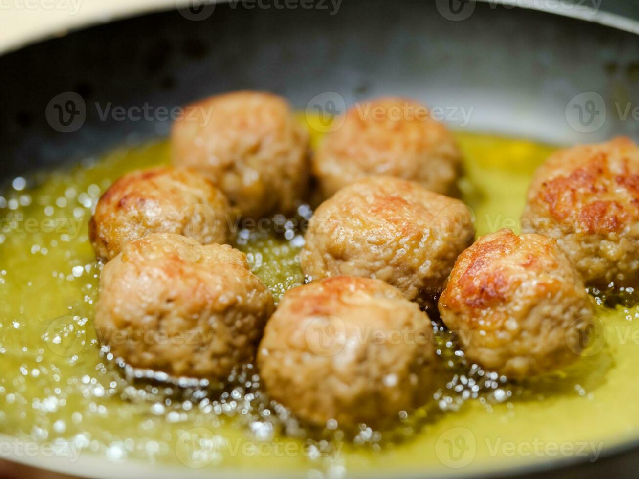 meatballs with oil in frying pan. photo