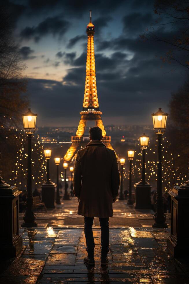 A man looking at eiffel tower at night Generative AI photo