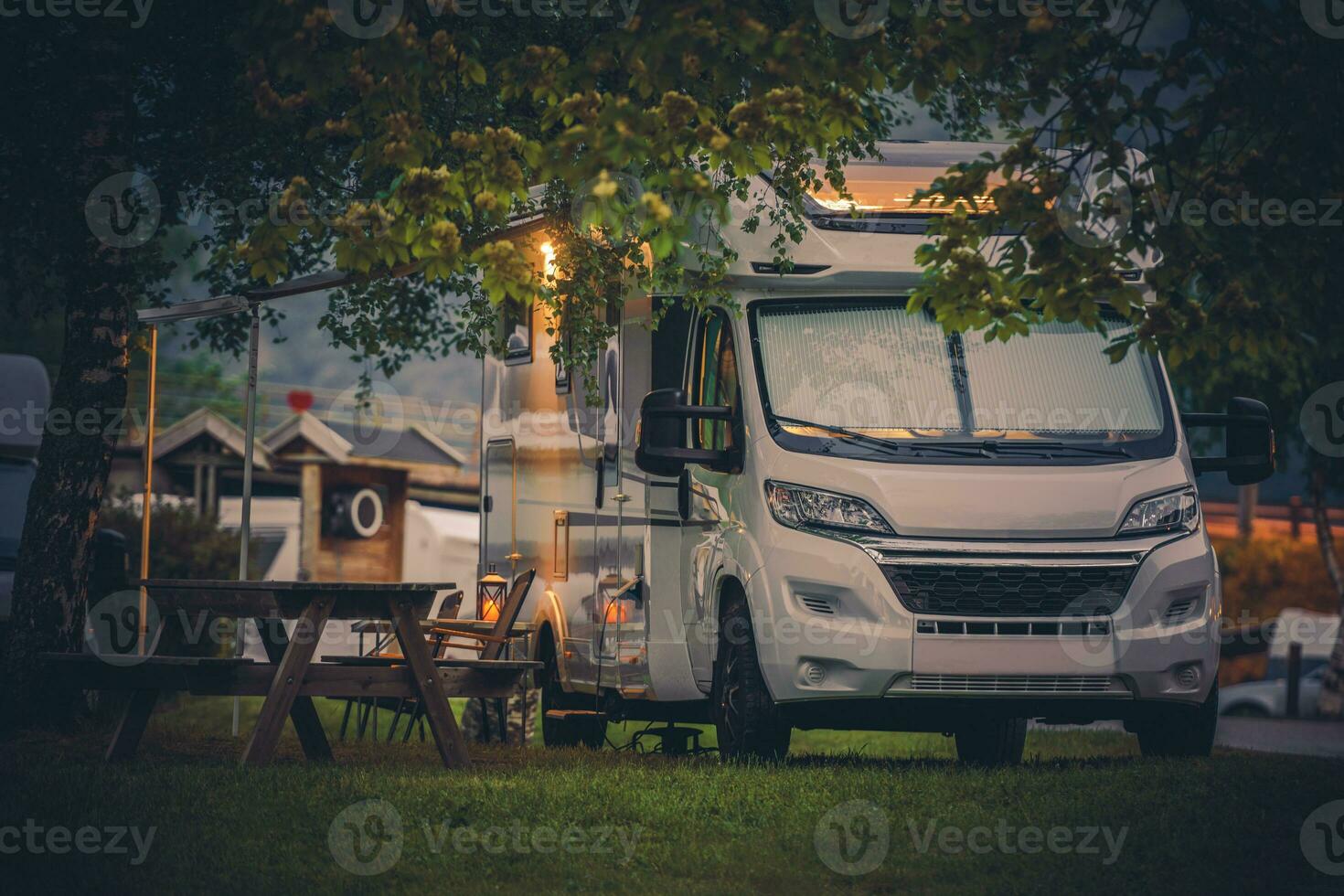 Modern RV Camper Van and a Camping Spot photo