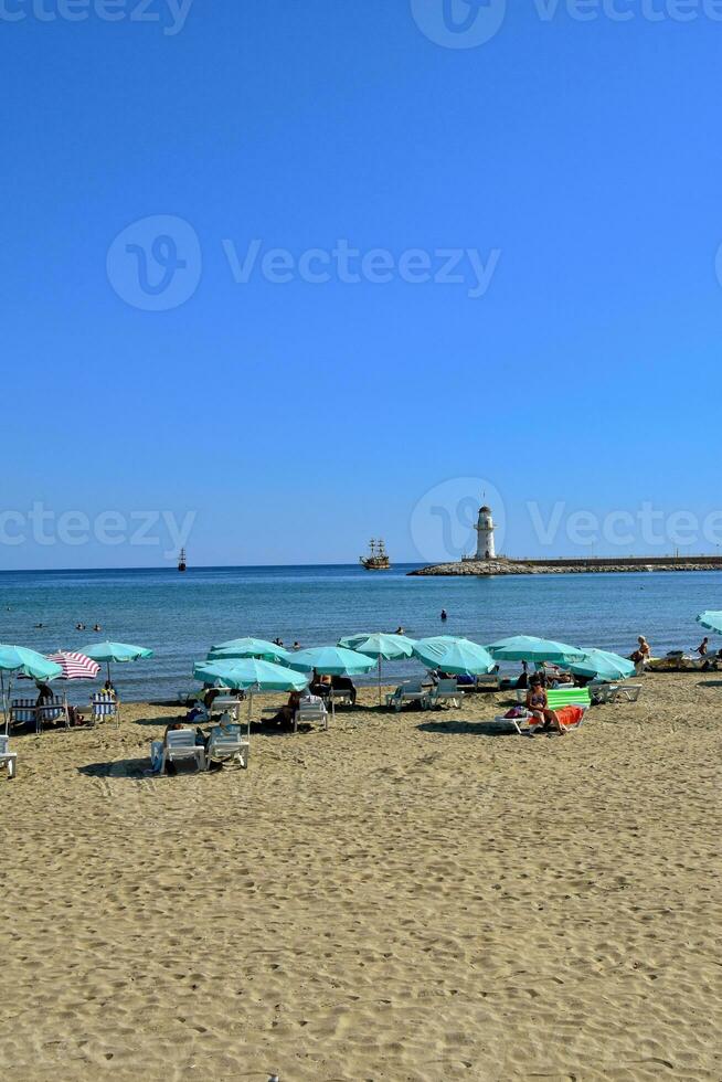 paisaje de el Puerto en el turco ciudad de Alanya con el blanco torre en un calentar verano día foto