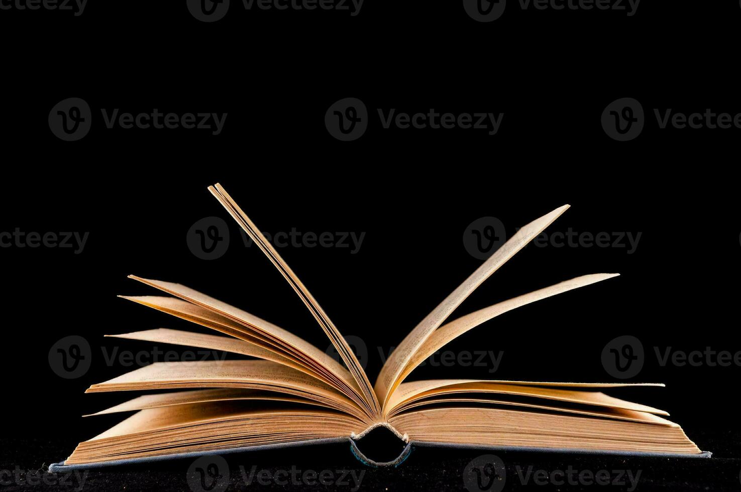 an open book on a black background photo