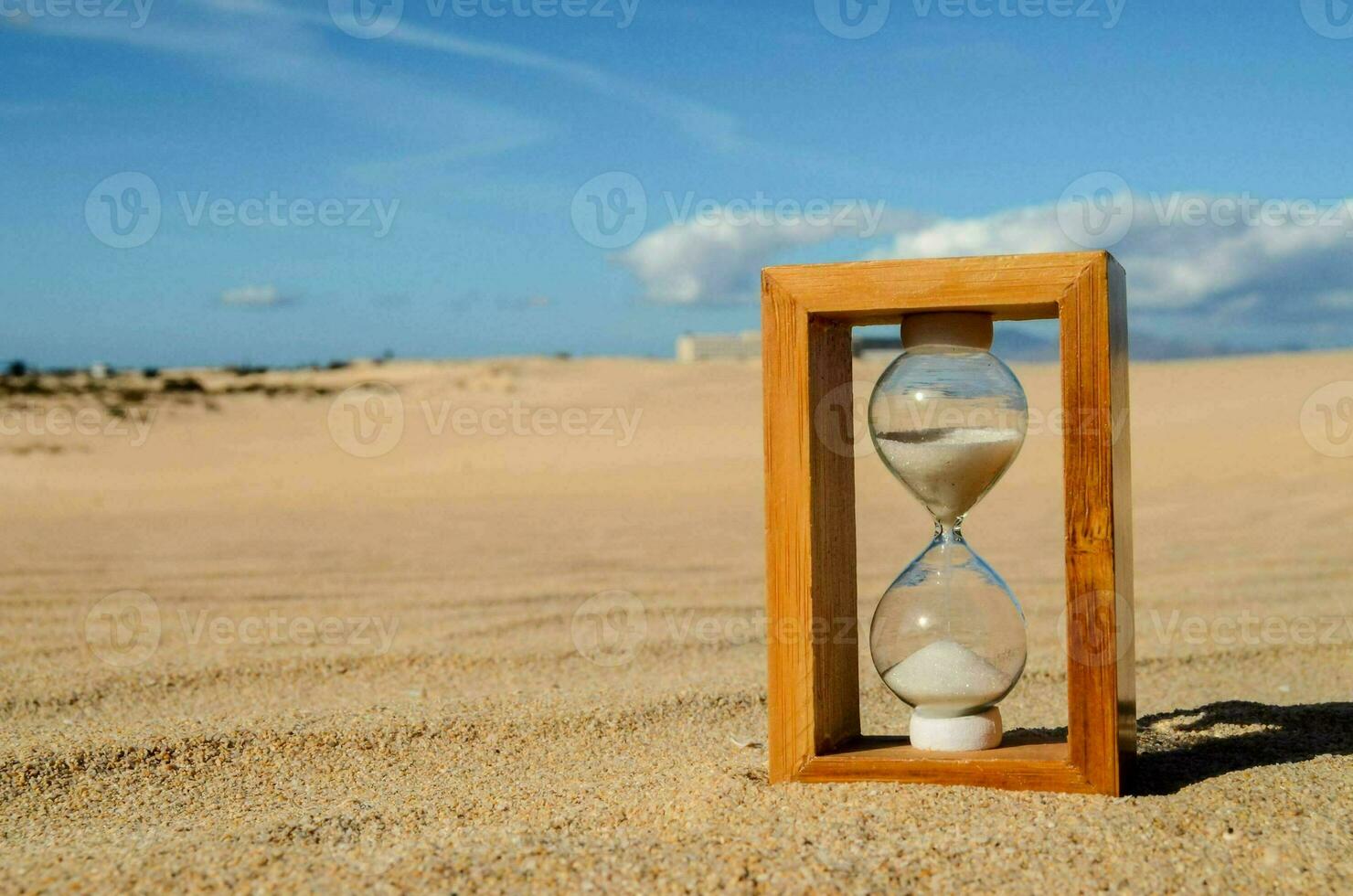 A hourglass in the sand photo