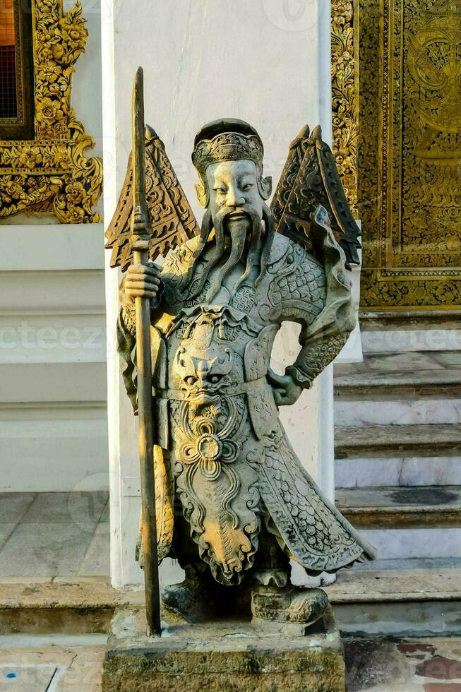 statue of a man with wings and a staff photo