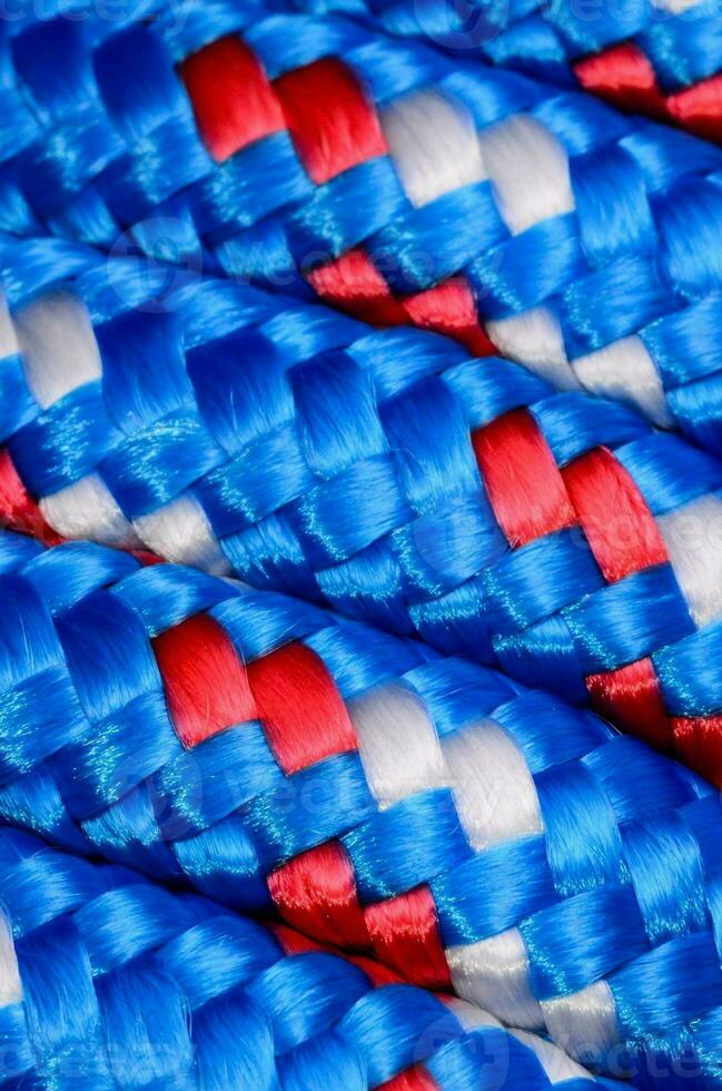 a close up of a blue, white and red braided rope photo