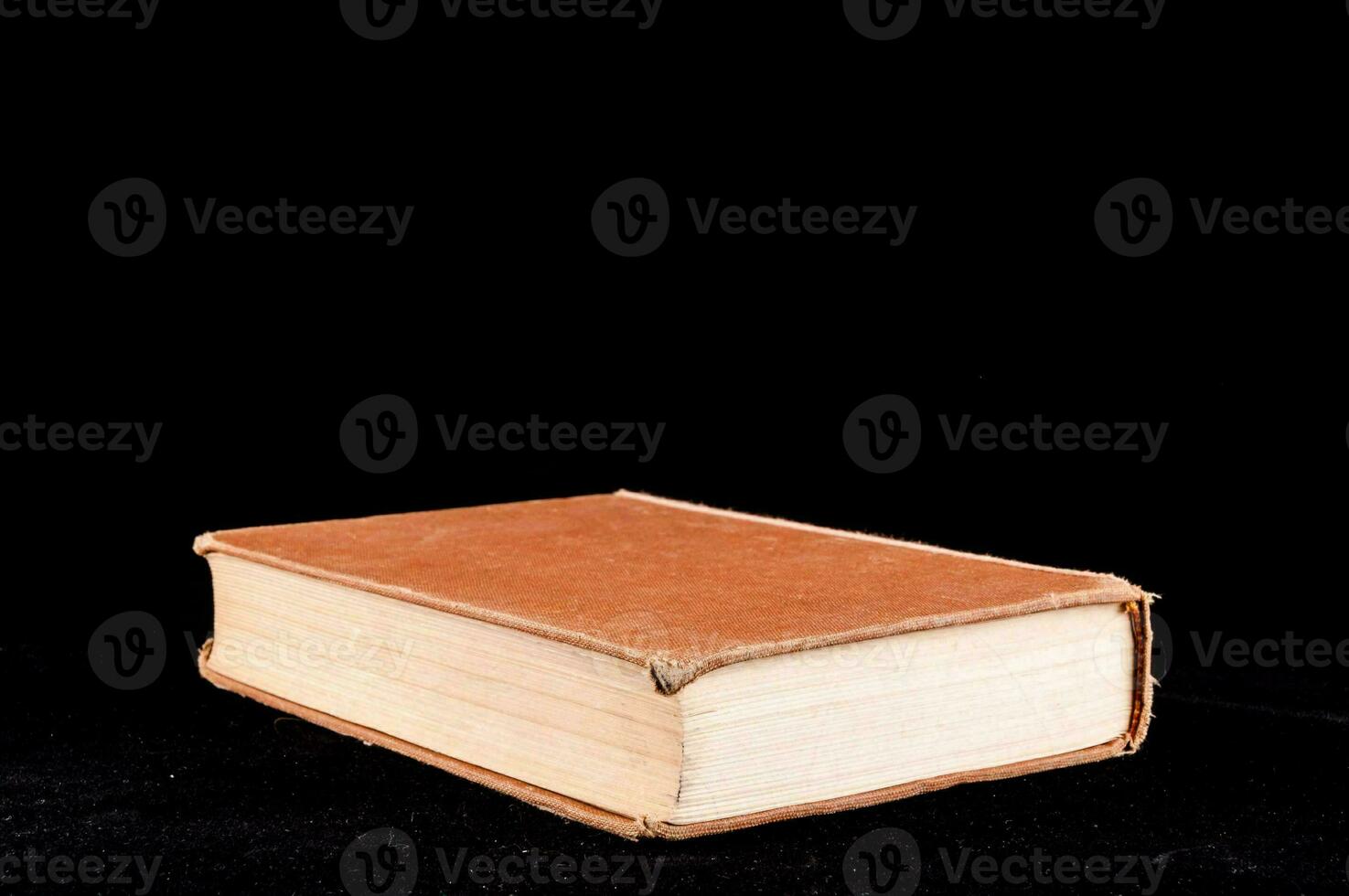 an old book on a black background photo