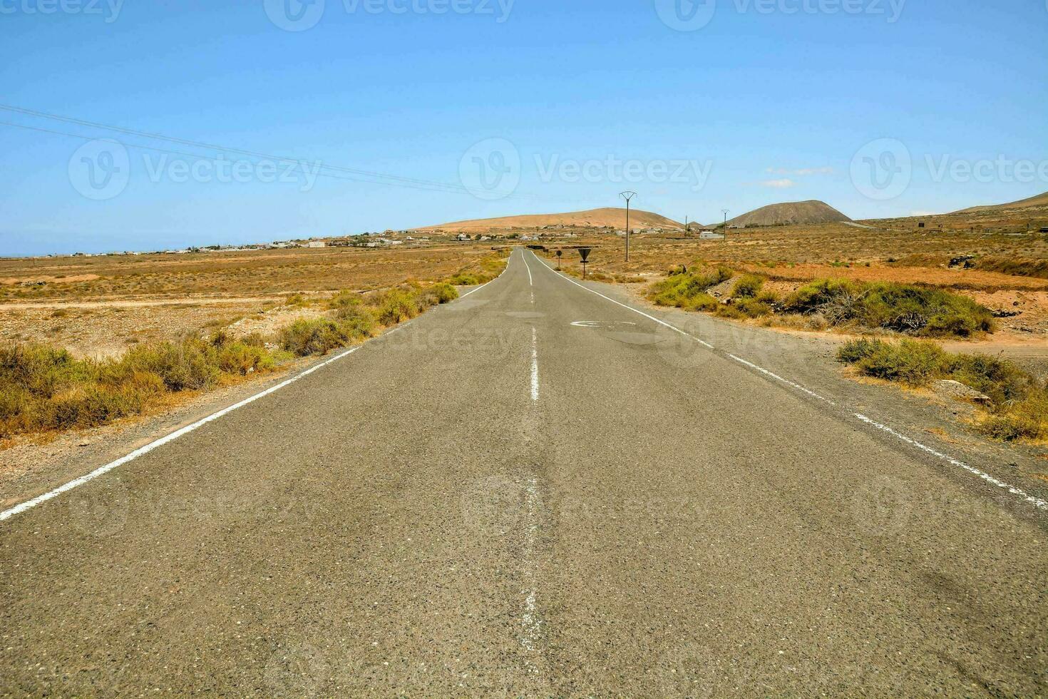 an empty road in the middle of nowhere photo
