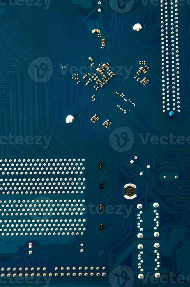 a close up of a blue electronic circuit board photo
