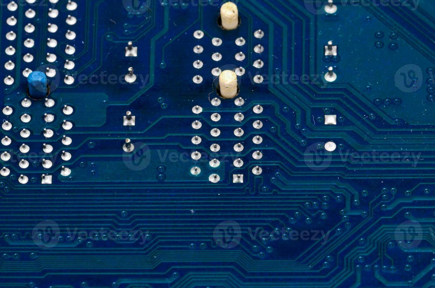 a close up of a blue electronic circuit board photo