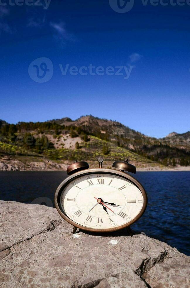 A clock on a rock photo